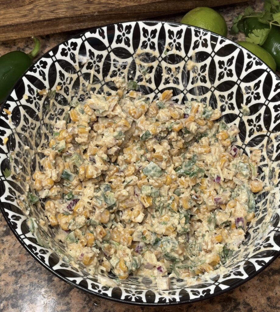 street corn mixed up in a bowl